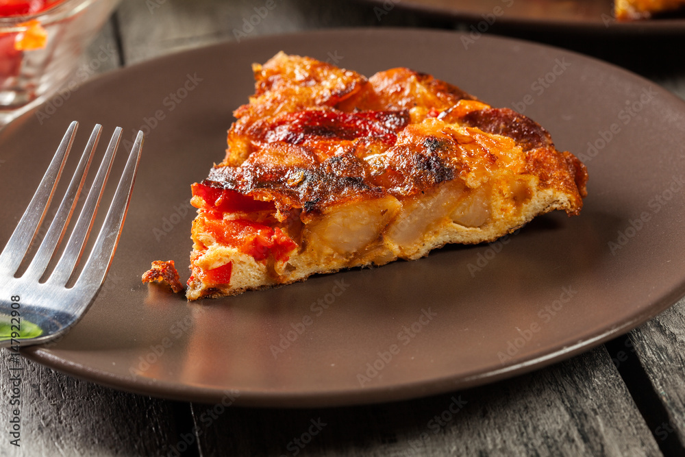 Tortilla de patatas. Spanish omelette with sausage chorizo, potatoes, paprika and egg, accompanied by olive oil Tortilla de patatas. Spanish omelette with sausage chorizo, potatoes, paprika and egg, accompanied by olive oil