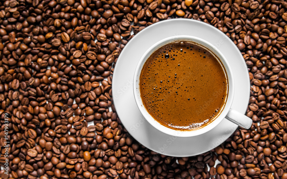 Coffee cup and coffee beans on table, top view, love coffee, Brown coffee beans isolated on white background, Hot Coffee cup with Coffee beans Coffee cup and coffee beans on table, top view, love coffee, Brown coffee beans isolated on white background, Hot Coffee cup with Coffee beans