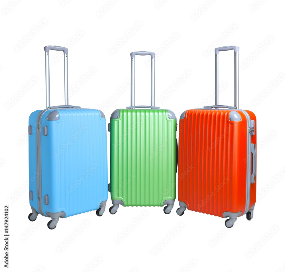 Three suitcases isolated on white background. Polycarbonate suitcases isolated on white. Blue, green and red suitcases. Three suitcases isolated on white background. Polycarbonate suitcases isolated on white. Blue, green and red suitcases.