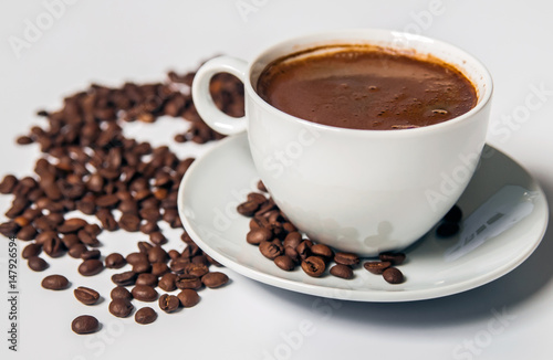 Coffee cup and beans on a white background.