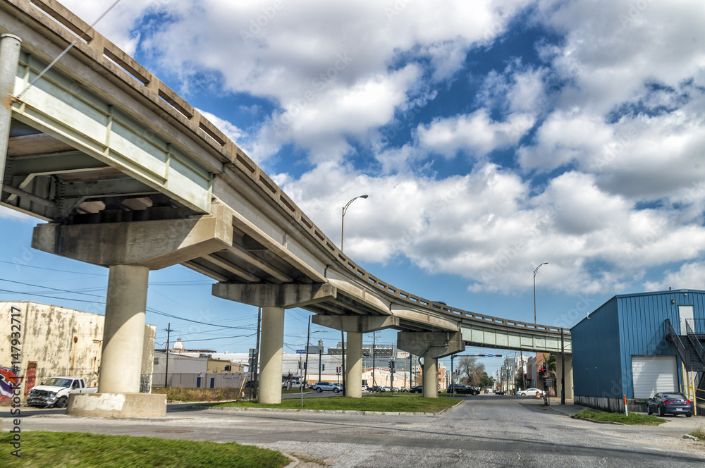 DIAMOND HEAD, MISSISSIPPI - FEBRUARY 2016: Interstate bridge over city buildings on a sunny day DIAMOND HEAD, MISSISSIPPI - FEBRUARY 2016: Interstate bridge over city buildings on a sunny day