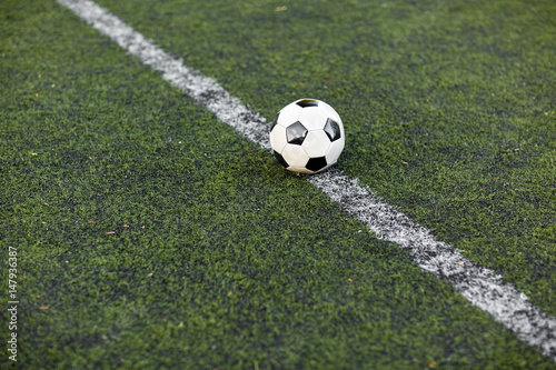 soccer ball on football field marking line © Syda Productions