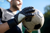 close up of goalkeeper with ball playing football