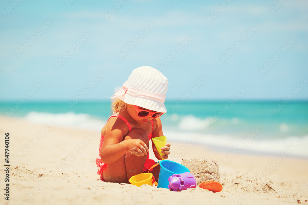 cute little girl play with sand on beach cute little girl play with sand on beach