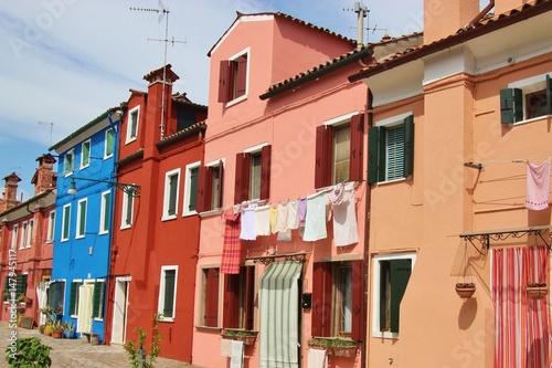  Bright colored houses and laundry hung up to dry on the island Burano, situated in the Lagoon of Venice, Italy, Europe. 