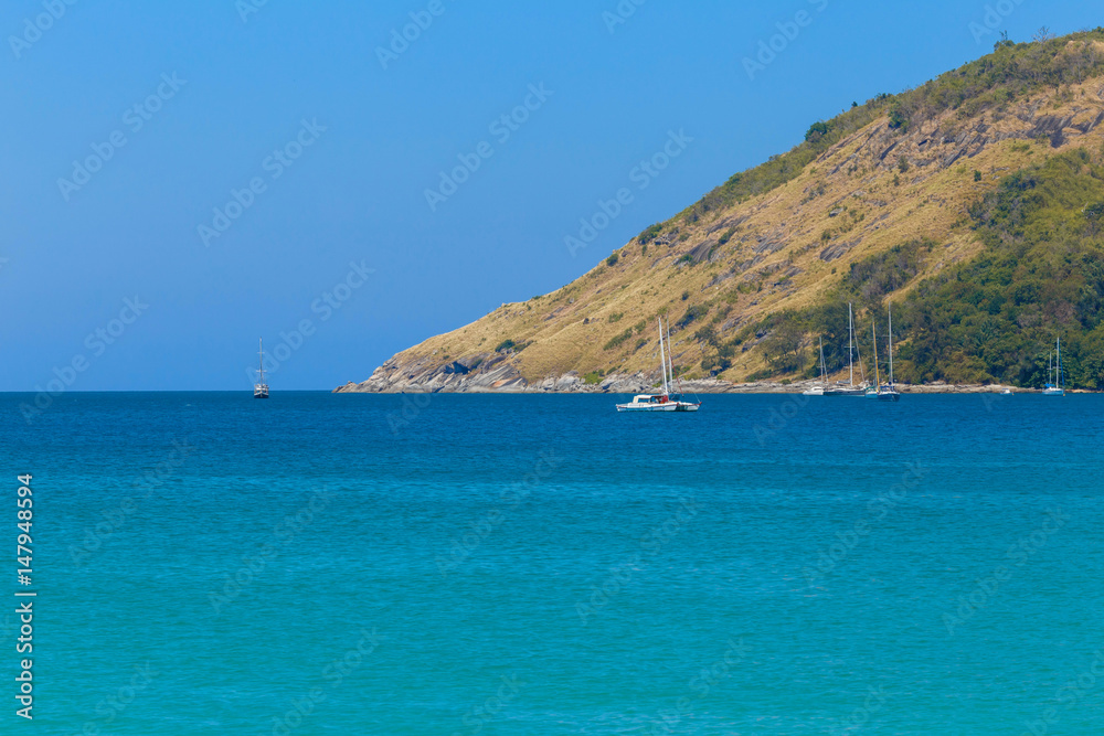 Fototapeta premium Mountains over transparent ocean water