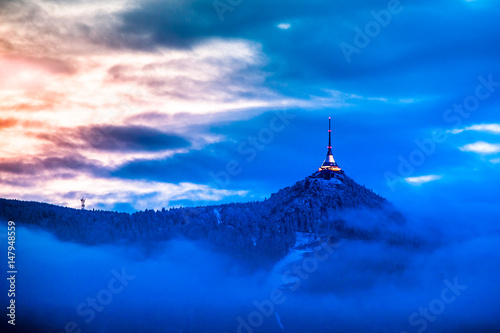 Illuminated Jested transmitter tower and hotel. Blue cloudy evening in Liberec, Czech Republic.