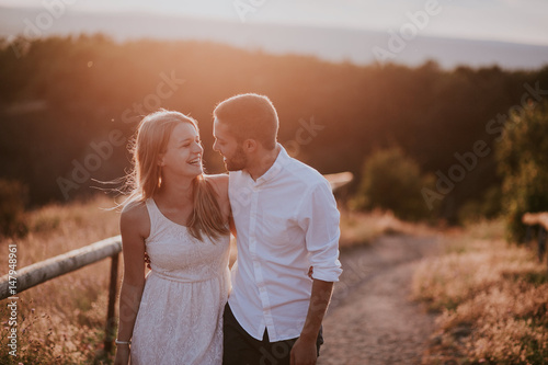 laughing couple with sundown