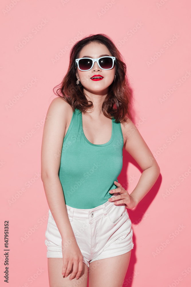 Summer asian young woman with professional makeup and stylish hairstyle on pink background. Summer asian young woman with professional makeup and stylish hairstyle on pink background.