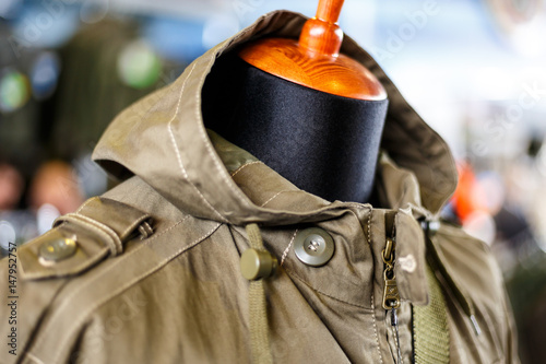 Hunting jackets and clothes hang on shelves in a hunting and fishing store