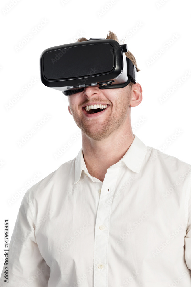 Man in a white shirt wearing a VR glasses, standing against a white background with his mouth wide open. Man in a white shirt wearing a VR glasses, standing against a white background with his mouth wide open.