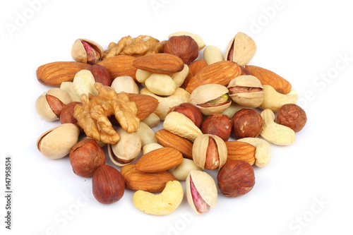 mix almonds, cashew nuts, hazelnut, peanuts, walnuts, pistachio in wood plate isolated on white background