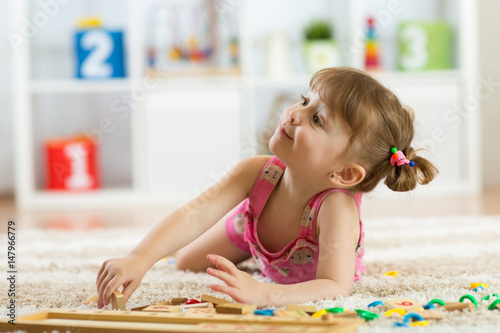 Cute little girl playing wi...