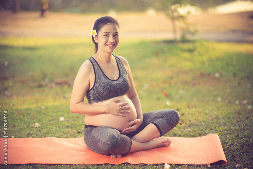 healthy pregnant woman doing yoga in nature outdoors.Vintage color healthy pregnant woman doing yoga in nature outdoors.Vintage color