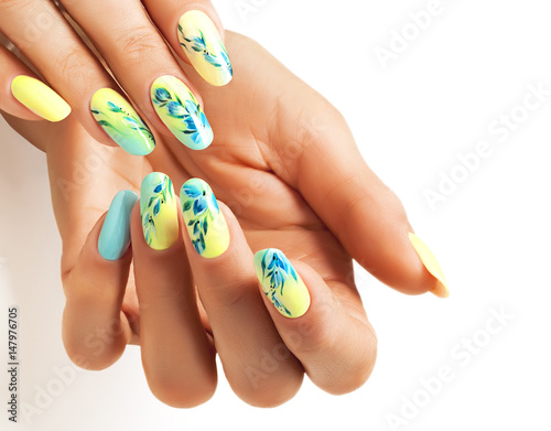Valokuva Art nails with a bright yellow-blue design.