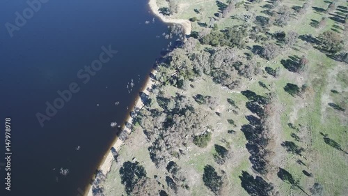 Lake forshore fly-over, slow tilt up to horizon