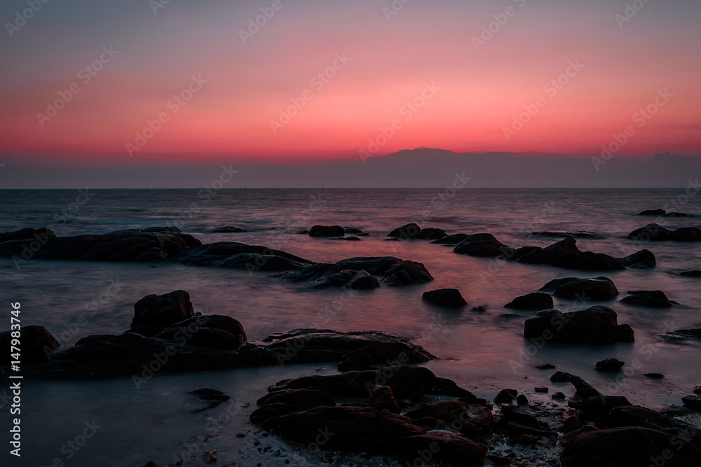 Rocks at sea side with silhouette theme sunset sky