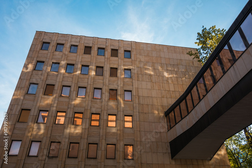 marble office building with glass bridge