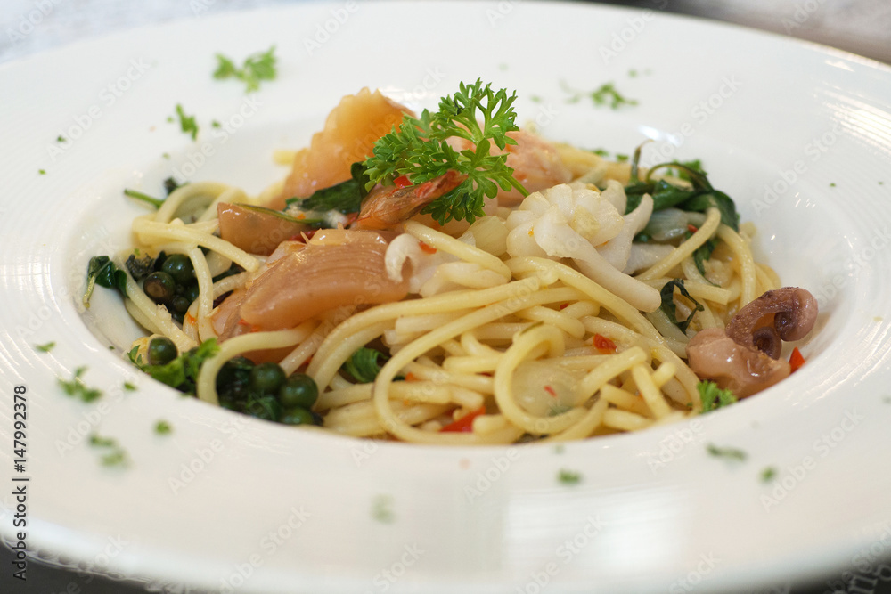 Spaghetti pasta sea food ingredient selective focus on white plate dish Spaghetti pasta sea food ingredient selective focus on white plate dish