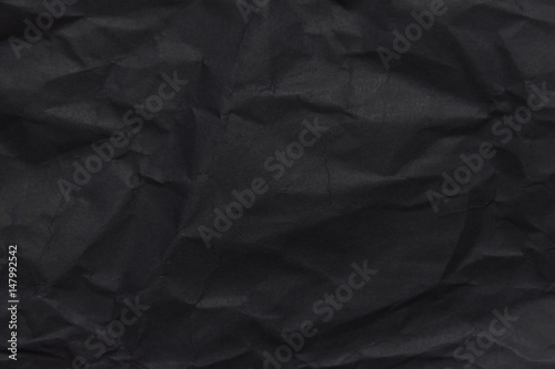 The background paper, crumpled black