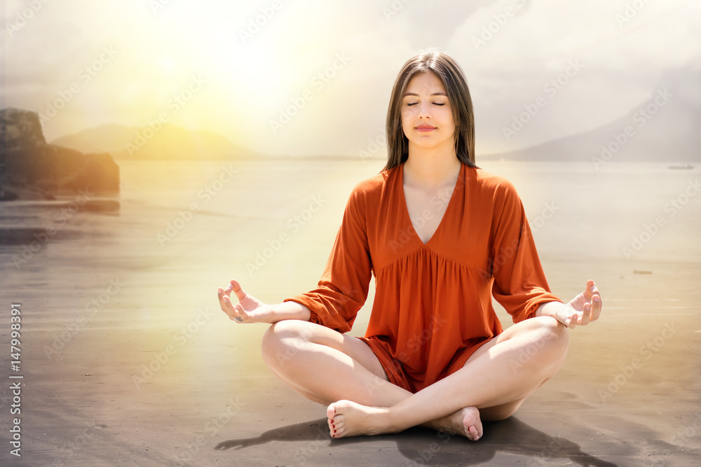 Fototapeta premium Young woman meditating at riverside.