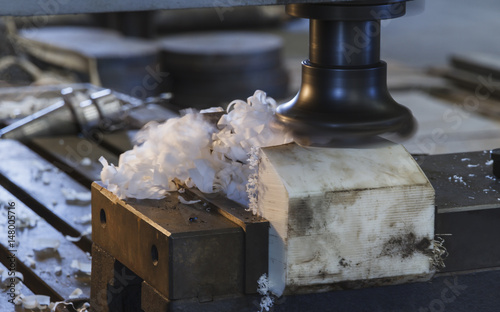Milling head cutting on Polyacetal(POM), Industrial metalworking cutting process by milling cutter machine.