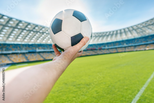 person holding soccer ball on soccer field stadium © LIGHTFIELD STUDIOS