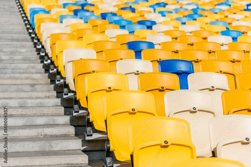 Fototapeta premium rows of yellow and blue stadium seats and stadium stairs