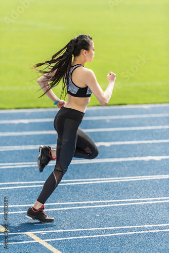 asian sportswoman training on running track stadium, young girl running concept