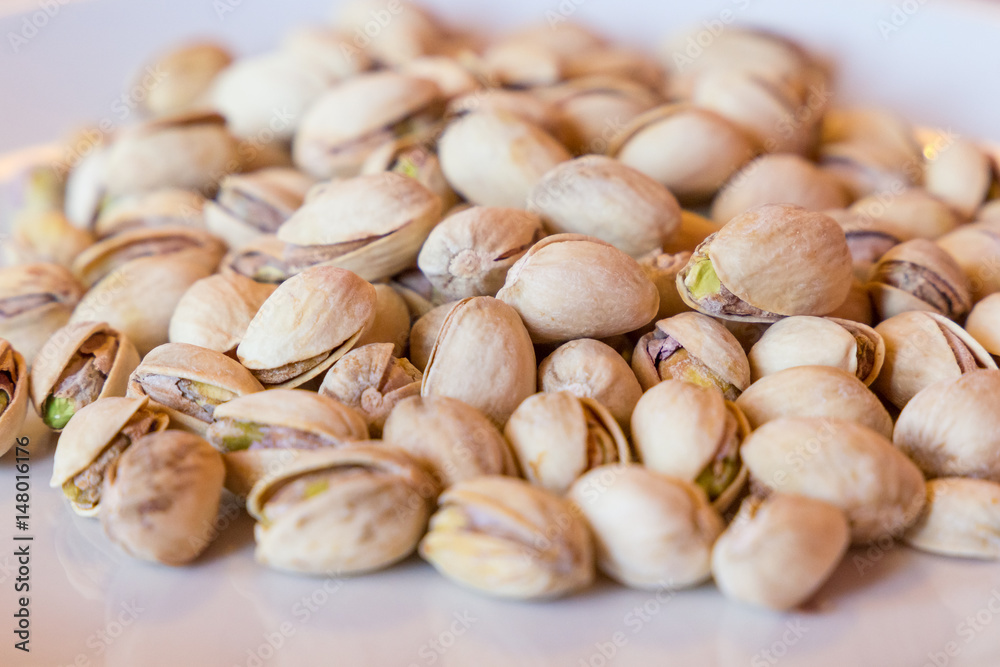 Delicious pistachios on a white plate