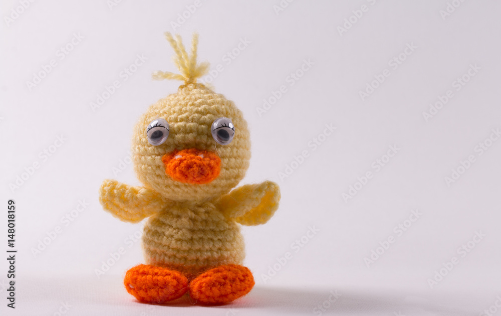 Crocheted woven cute little duck toy close-up Crocheted woven cute little duck toy close-up