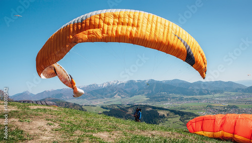 Paraglider catch a wind with his paraplane
