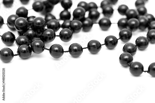 Black beads on a white background