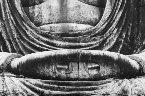closeup of body and maditating hands of Great Buddha Daibutsu (Amida Buddha) statue of Kotokuin Temple in Kamakura, Tokyo. black and white photo. photo