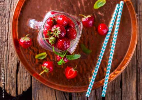 Fresh Strawberries in a glass Jar for Drinks on Vintage wooden background.Food or Healthy diet concept.Vegetarian.Copy space for text. selective focus