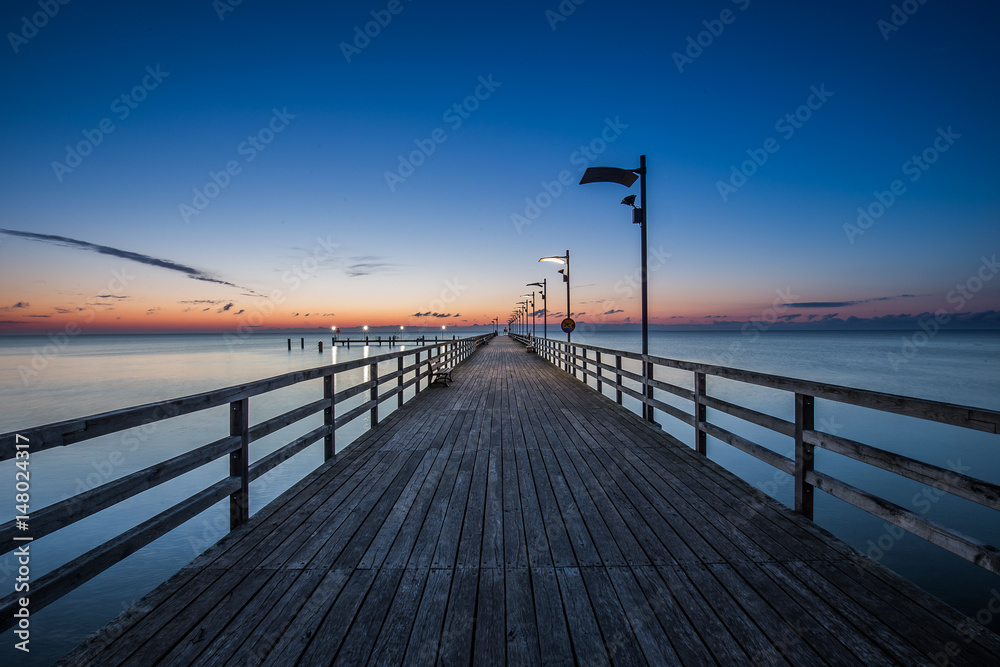 Wooden pier in Mechelinki. Small fishing village in Poland. Amazing Sunrise at the beach