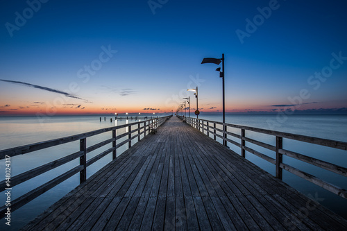 Fototapeta Naklejka Na Ścianę i Meble -  Wooden pier in Mechelinki. Small fishing village in Poland. Amazing Sunrise at the beach
