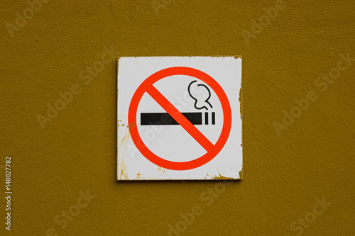 No smoking sign on brown wall