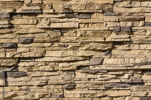 Flat rocks layered to form a solid wall photo