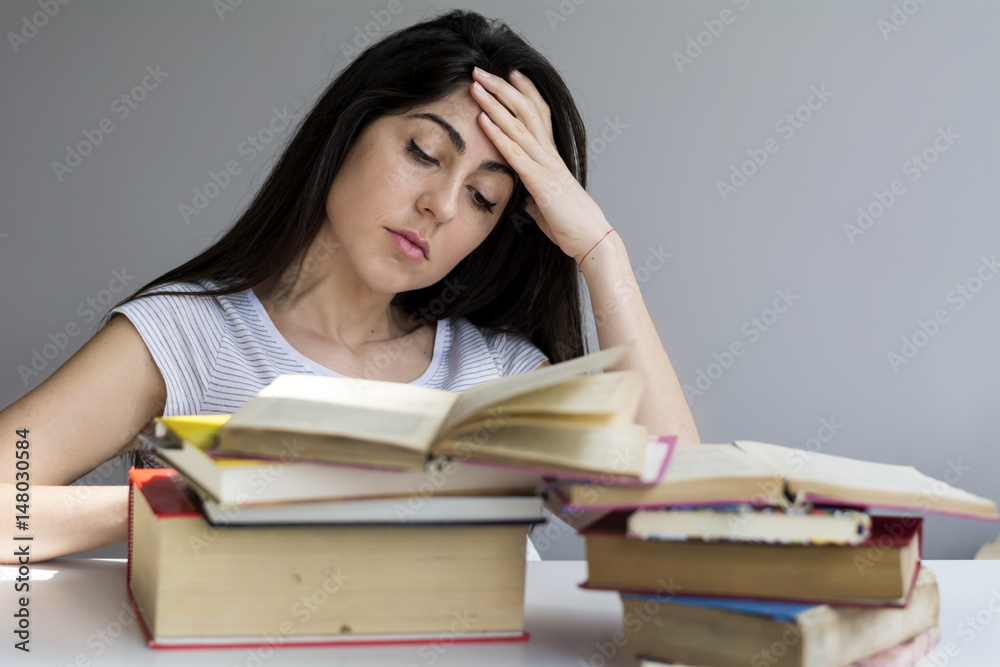 tired and sad  student  woman with books worried about exams