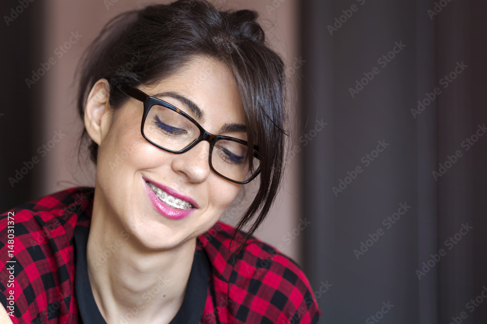 Portrait of a beautiful woman with braces on teeth. Orthodontic Treatment. Dental care Concept Portrait of a beautiful woman with braces on teeth. Orthodontic Treatment. Dental care Concept