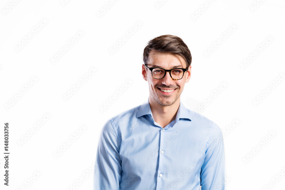 Handsome young man in blue shirt. Studio shot, isolated. Handsome young man in blue shirt. Studio shot, isolated.