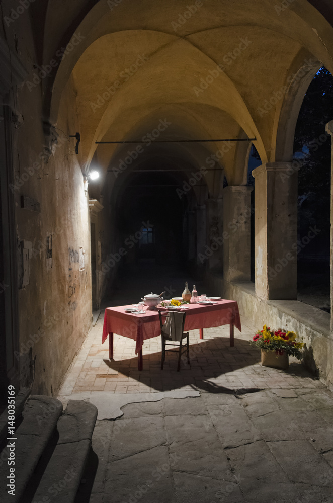 Laid table inside a cloister