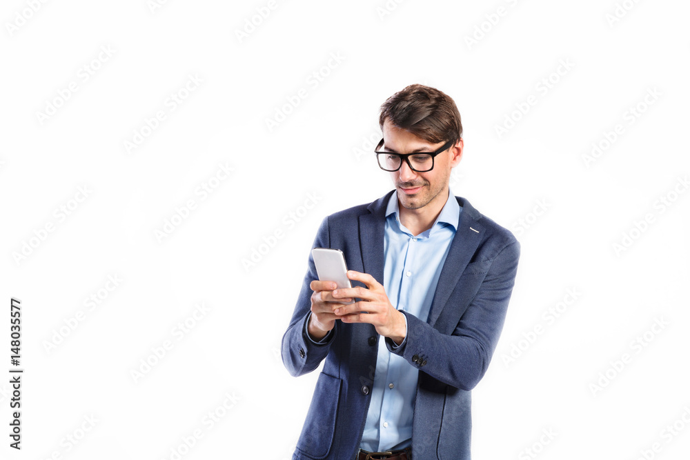 Handsome young man with smart phone. Studio shot, isolated. Handsome young man with smart phone. Studio shot, isolated.