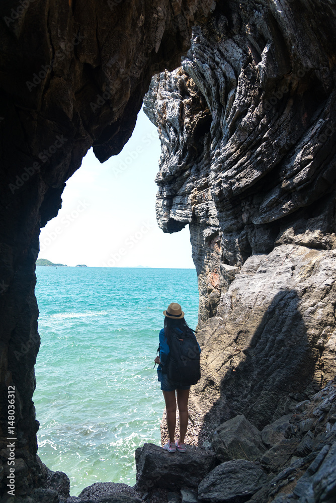 Travel women in a cave near the sea in Keo Sichang, Thailand