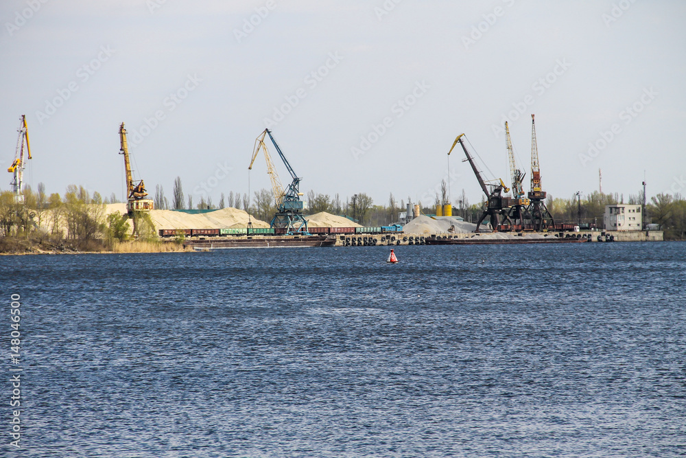Harbor cranes at cargo port on the river Dnieper in Kremenchug, Ukraine