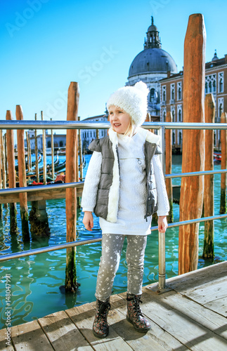 child on embankment in Venice, Italy in winter looking aside photo