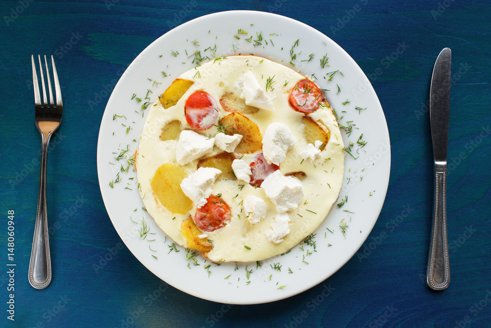 Beautiful omelette with tomato, potato and greek cheese Beautiful omelette with tomato, potato and greek cheese