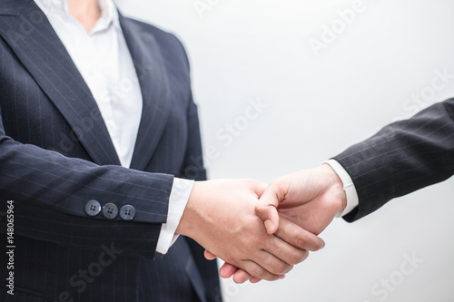 confident business man shaking hands during a meeting to aim dealing success and partner concept in the office .