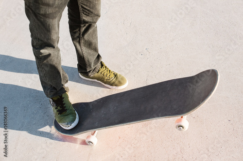Close-up of skateboarders foot while skating in skate park